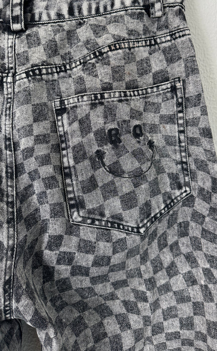 Geblokte jeans met asymmetrische sluiting